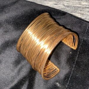 Bracelet thick gold colored.